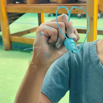 Criança mostrando um coração feito em atividade de arte